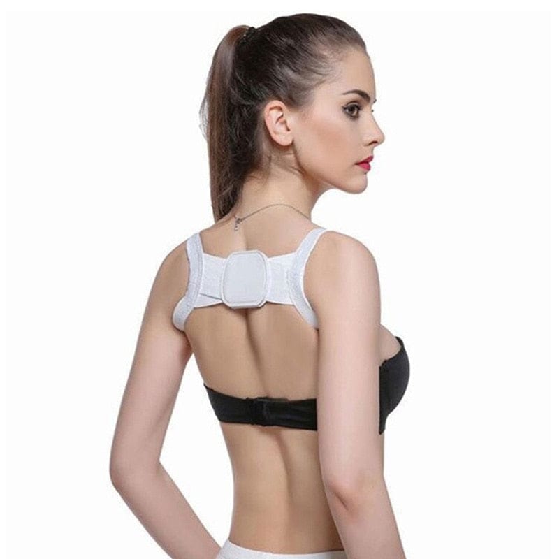 Woman wearing a white back brace on a white background
